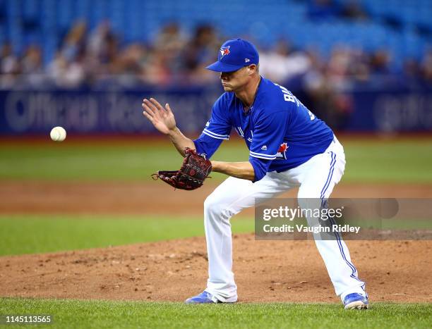 Clay Buchholz of the Toronto Blue Jays fields the ball during a MLB game against the San Francisco Giants at Rogers Centre on April 24, 2019 in...