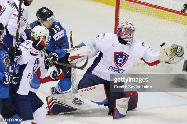 Florian Hardy of France stops the puck against Veli-Matti Savinainen of Finland during the 2019 IIHF Ice Hockey World Championship Slovakia group A...