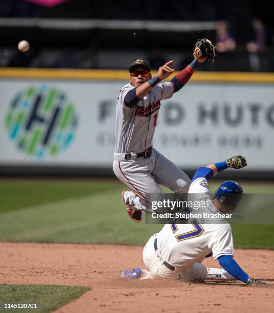 Shortstop Jorge Polanco of the Minnesota Twins tries to turn a double play after forcing out Ryon Healy of the Seattle Mariners at second base on a...