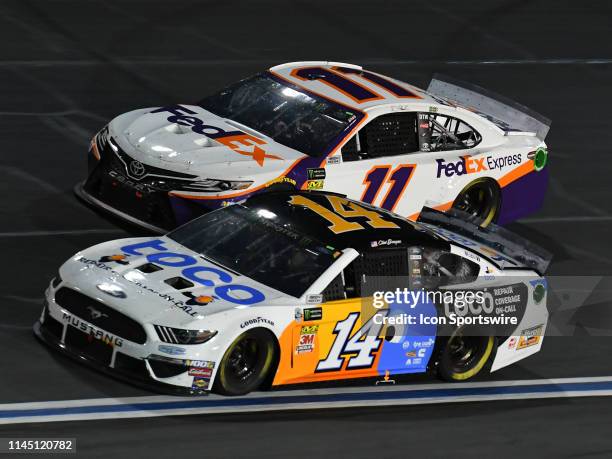 Clint Bowyer, Stewart-Haas Racing, Ford Mustang Toco Warranty and Denny Hamlin, Joe Gibbs Racing, Toyota Camry FedEx Express race side by side during...