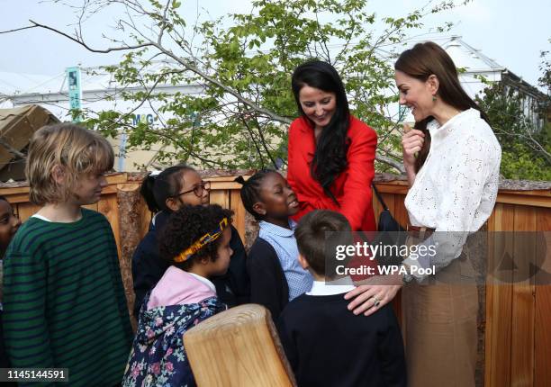 Catherine, Duchess of Cambridge speaks children during a visit to her garden at the RHS Chelsea Flower Show at the Royal Hospital Chelsea on May 20,...