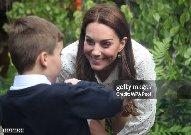 Catherine, Duchess of Cambridge speaks children during a visit to her garden at the RHS Chelsea Flower Show at the Royal Hospital Chelsea on May 20,...