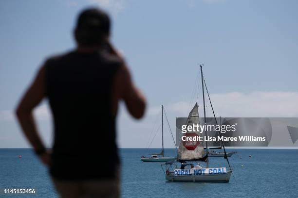 Man looks out at Airlie Bay as a boat launches a sail in protest to the Adani Carmichael Coal Mine proposal on April 26, 2019 in Airlie Beach,...