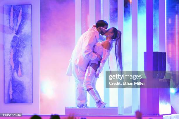 Anuel AA and Karol G kiss as they perform during the 2019 Billboard Latin Music Awards at the Mandalay Bay Events Center on April 25, 2019 in Las...