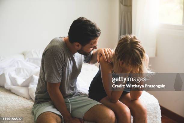 loving husband comfort upset offended wife, caressing and hugging - rupture photos et images de collection