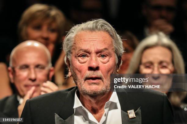 French actor Alain Delon reacts as he is awarded with an Honorary Palme d'Or at the 72nd edition of the Cannes Film Festival in Cannes, southern...