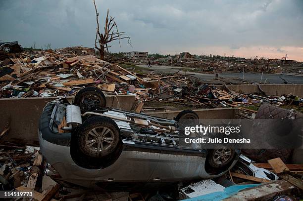 An overturned car lies on the foundation of a home near St. John's Regional Medical Center on May 23, 2011 in Joplin, Missouri. A powerful tornado...