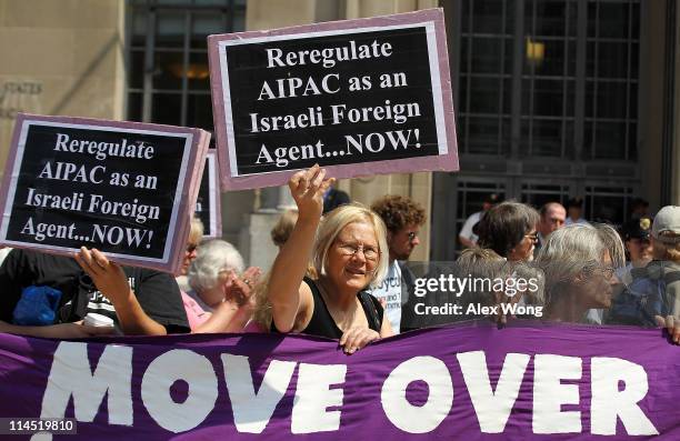 Activist Ann Wright of Code Pink holds up a sign as she protests against the American Israel Public Affairs Committee outside Department of Justice...