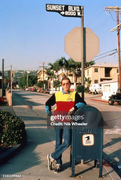 Austrian Film actor Helmut Berger, star of TV series "Dynasty" leans on mailbox along Sunset Boulevard in Los Angeles, California circa 1985;