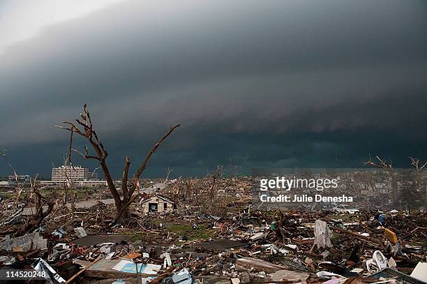 Destroyed homes and debris cover the ground as a second storm moves in on May 23, 2011 in Joplin, Missouri. A powerful tornado ripped through the...