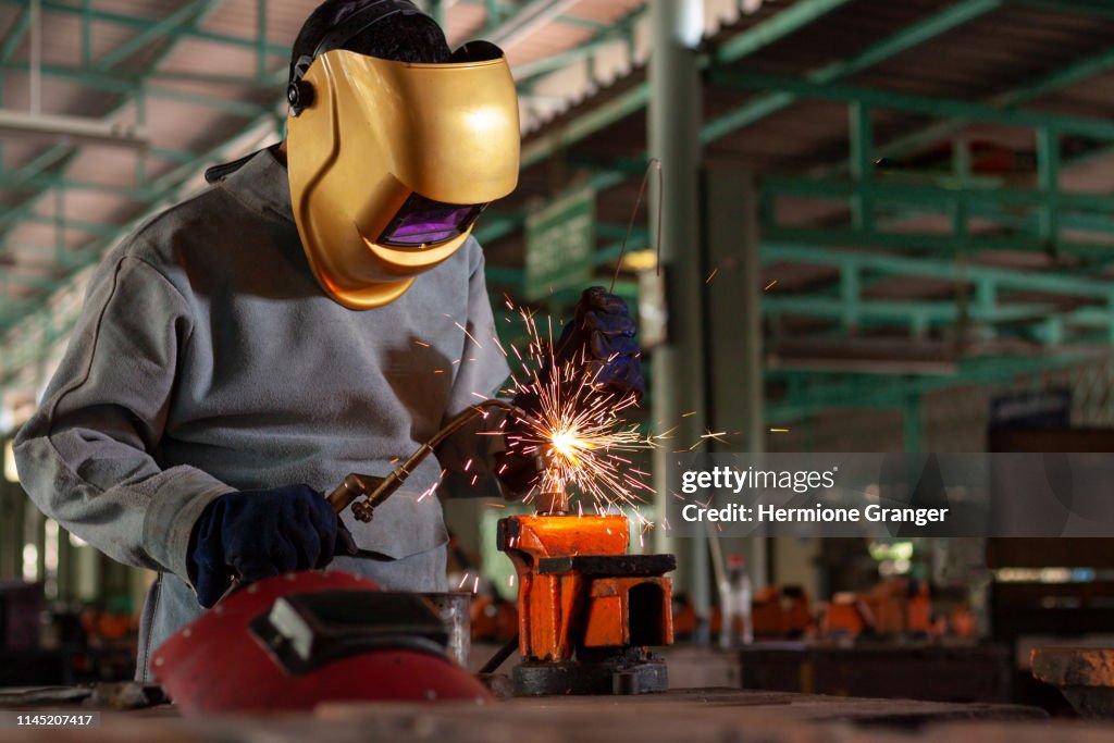 Welder steel welding worker industry industrial metal factory spark construction protection work manufacturing safety man job mask labor light laborer manufacture craftsman equipment skilled skill technical iron