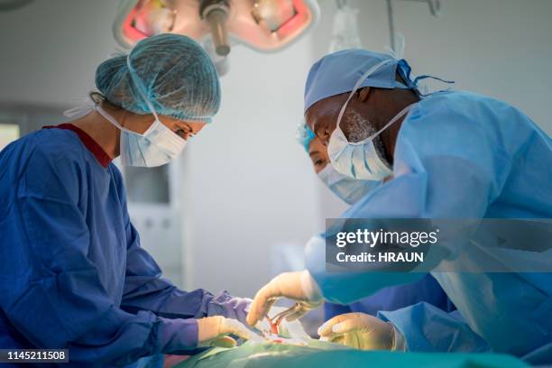 Doctors Operating 1,192 Black Doctor Working In Operating Room Stock Photos, High-Res ...