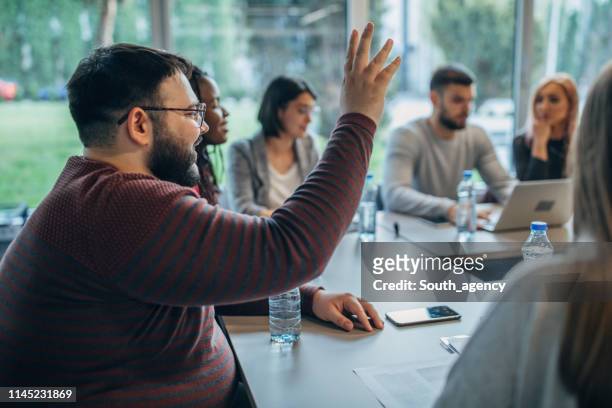 group of young people on board meeting in firm - men and women in a large group listening stock pictures, royalty-free photos & images