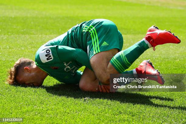 Gerard Deulofeu of Watford lies injured during the Premier League match between Huddersfield Town and Watford FC at John Smith's Stadium on April 20,...