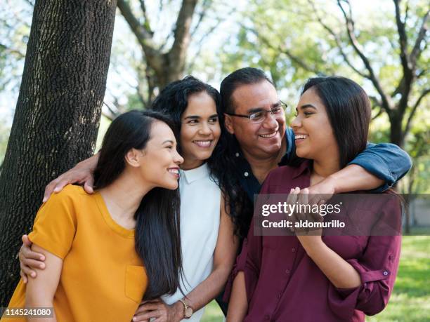 young woman smiling at her family - mexican culture stock pictures, royalty-free photos & images