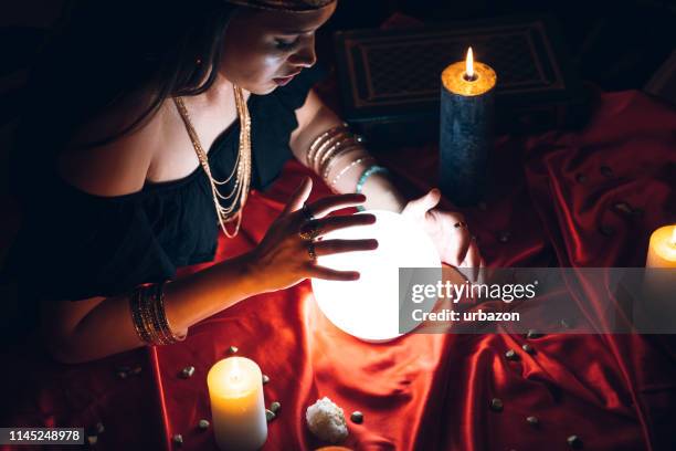 fortune teller and crystal sphere - fortune teller table stock pictures, royalty-free photos & images