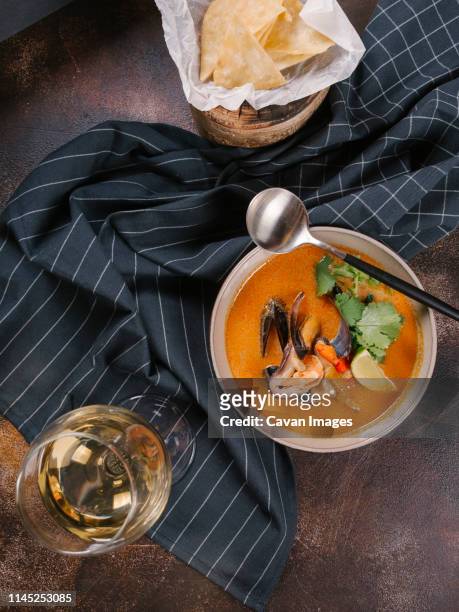 shrimp and mussel soup served with white wine on table - mussels stockfoto's en -beelden