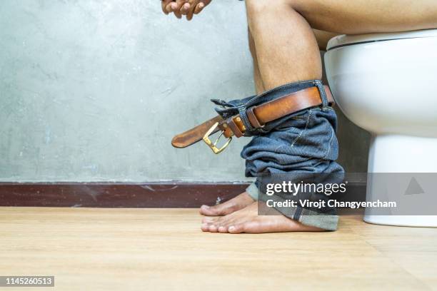 nude picture, man sitting on toilet bowl in the toilet, constipation concept. - toilettes photos et images de collection