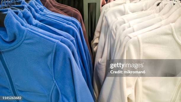 cloths in fashion store - fleece stockfoto's en -beelden