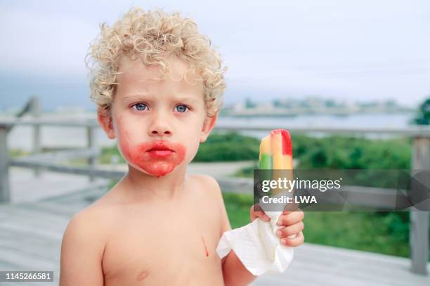 young boy eating popsicle - boy curly blonde stock pictures, royalty-free photos & images