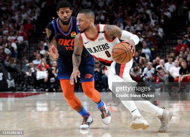 Damian Lillard of the Portland Trail Blazers drives to the basket on Paul George of the Oklahoma City Thunder during the second half of Game Five of...