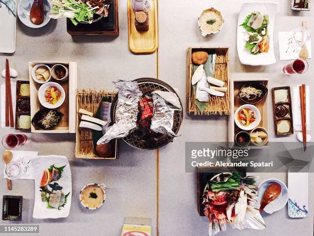 directly above view of traditional japanese dinner in ryokan - japanese food stock pictures, royalty-free photos & images