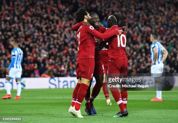 Naby Keita of Liverpool celebrates after scoring his team's first goal with Mohamed Salah and Sadio Mane during the Premier League match between...