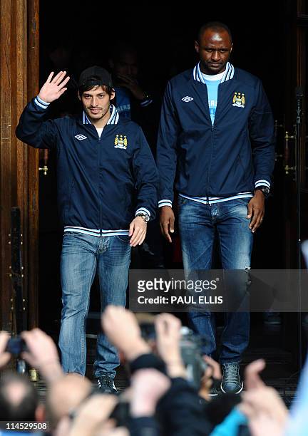 Manchester City's Spanish midfielder David Silva waves as he leaves with Manchester City's French midfielder Patrick Vieira at Manchester Town Hall...