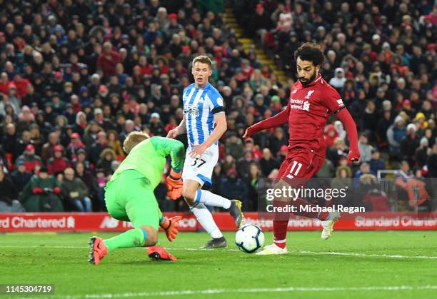 Mohamed Salah of Liverpool scores his team's fifth goal past Jonas Lossl of Huddersfield Town during the Premier League match between Liverpool FC...
