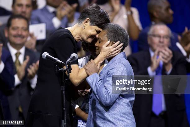 Lori Lightfoot, mayor of Chicago, right, embraces her wife Amy Eshleman after taking the oath of office during an inauguration ceremony in Chicago,...