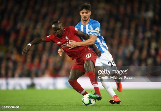 Sadio Mane of Liverpool battles with Christopher Schindler of Huddersfield Town during the Premier League match between Liverpool FC and Huddersfield...