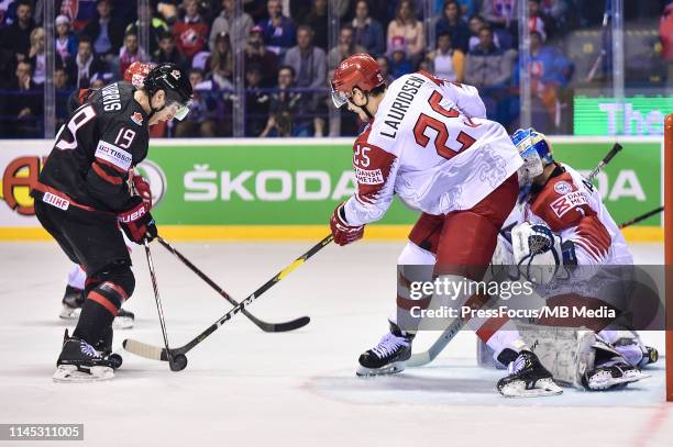 Oliver Lauridsen of Denmark tackles Kyle Turris of Canada during the 2019 IIHF Ice Hockey World Championship Slovakia group A game between Canada and...