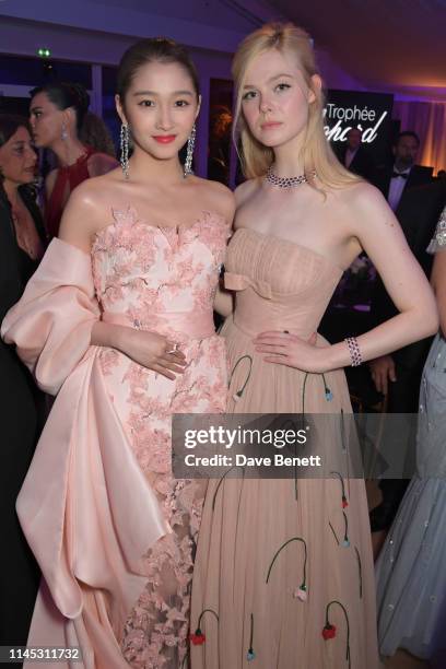 Guan Xiaotong and Elle Fanning attend the official Trophee Chopard dinner as part of the 72nd Cannes International Film Festival at Agora on May 20,...