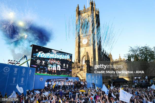 Manchester City players and staff celebrate during the Manchester City trophy parade in Manchester on May 20, 2019 in Manchester, England.