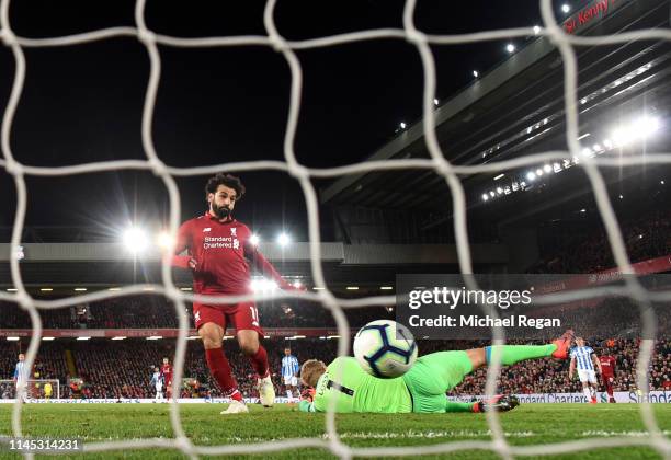 Mohamed Salah of Liverpool scores his team's fifth goal past Jonas Lossl of Huddersfield Town during the Premier League match between Liverpool FC...