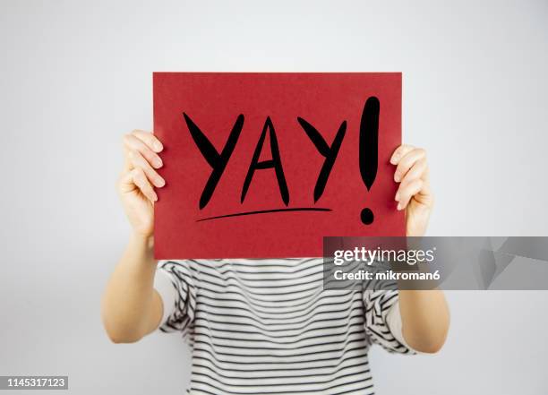 woman showing a paper page with yay! - exclamation mark stock pictures, royalty-free photos & images
