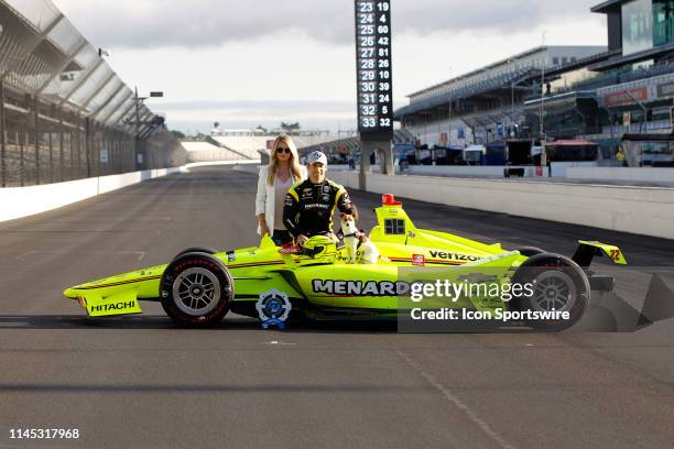 Pole winner IndyCar driver Simon Pagenaud of the Menards Team Penske Chevrolet and his fiancee Hailey McDermott along with their dog Norman during...