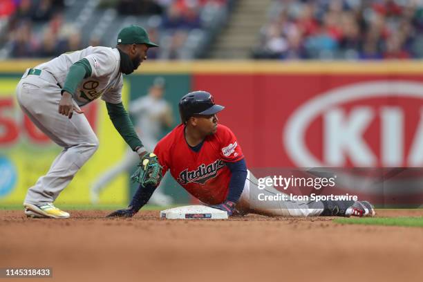 Cleveland Indians third baseman Jose Ramirez beats the tag of Oakland Athletics infielder Jurickson Profar as he is safe at second base with a double...