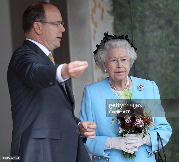 Britain's Queen Elizabeth II listens as Prince Albert II of Monaco gestures as he speaks as they visit the Monaco Garden at the Chelsea Flower Show...