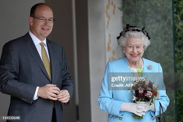 Britain's Queen Elizabeth II and Prince Albert II of Monaco visit the Monaco Garden at the Chelsea Flower Show press and VIP day in London on May 23,...