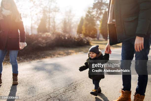 family walk - winter baby stock pictures, royalty-free photos & images