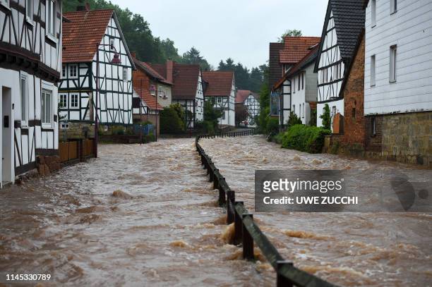 The river Losse, that has its bed on the right side of the picture, floods the city of Kaufungen near Kassel, central Germany, on May 21 after heavy...