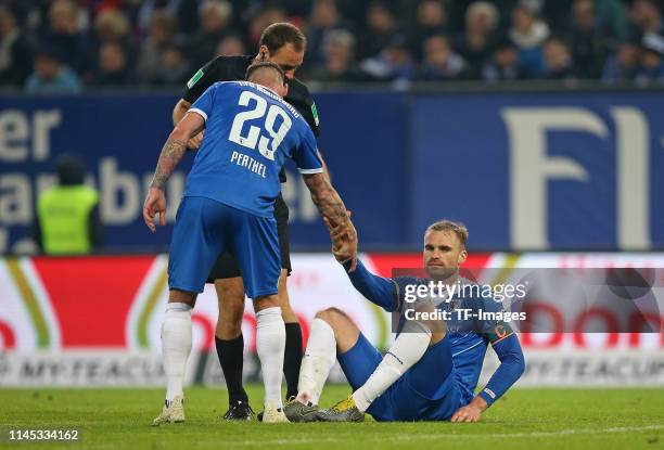 Timo Perthel of 1. FC Magdeburg helps Jan Kirchhoff of 1. FC Magdeburg during the Second Bundesliga match between Hamburger SV and 1. FC Magdeburg at...