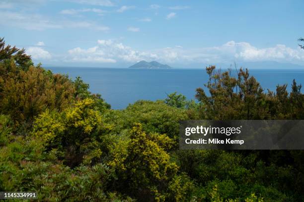 Blue sky with clouds view towards the island of Atokos at Gidaki beach near Vathy, Ithaca, Greece. Ithaca, Ithaki or Ithaka is a Greek island located...