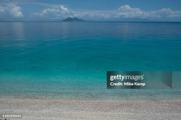 Blue sky with clouds view towards the island of Atokos at Gidaki beach near Vathy, Ithaca, Greece. Ithaca, Ithaki or Ithaka is a Greek island located...