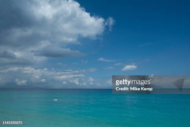 Blue sky with clouds view towards the island of Atokos at Gidaki beach near Vathy, Ithaca, Greece. Ithaca, Ithaki or Ithaka is a Greek island located...