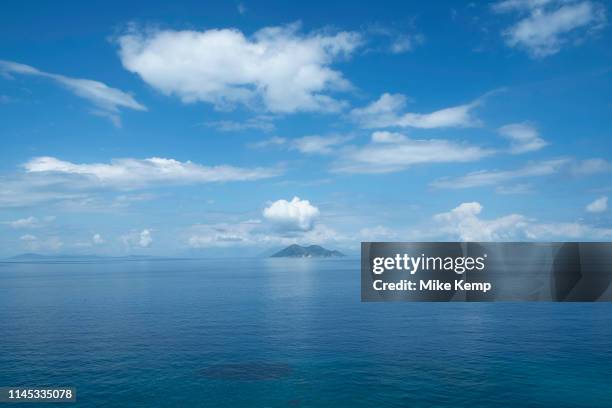 Blue sky with clouds view towards the island of Atokos at Gidaki beach near Vathy, Ithaca, Greece. Ithaca, Ithaki or Ithaka is a Greek island located...