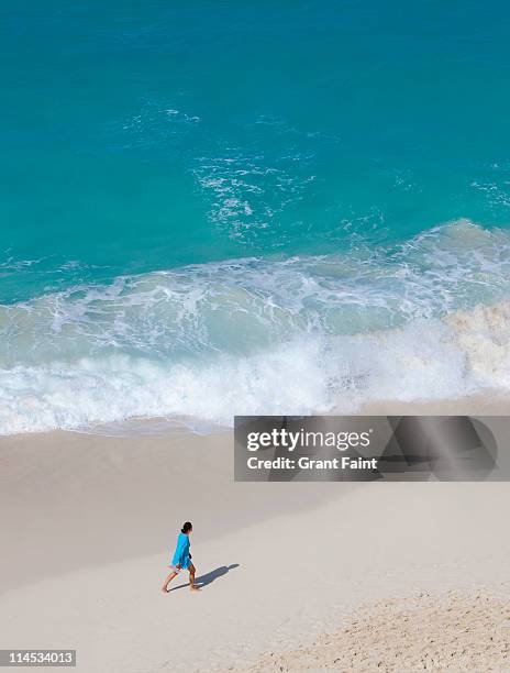 woman walking on beach. - nassau beach stock pictures, royalty-free photos & images