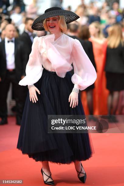 Actress and member of the jury of the Cannes Film Festival Elle Fanning laughs as she arrives for the screening of the film "Once Upon a Time... In...