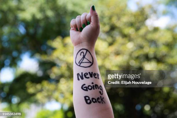 Melissa Simpson holds up her arm with "Never Going Back" written on it during a protest against recently passed abortion ban bills at the Georgia...